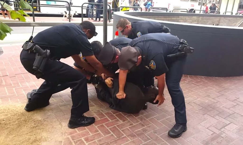 A still captured of SFPD officers pinning a disabled man to the ground after mistaking his crutches for weapons. Image courtesy of Chaédria LaBouvier