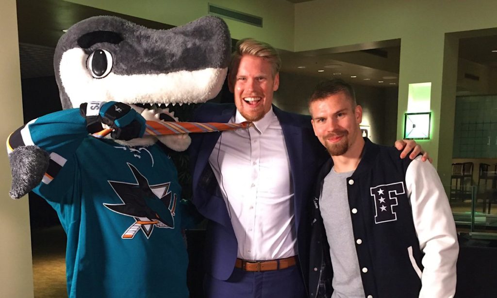 Donskoi (right) with the team's mascot, SJ Sharkie, and in-arena host Jon Root