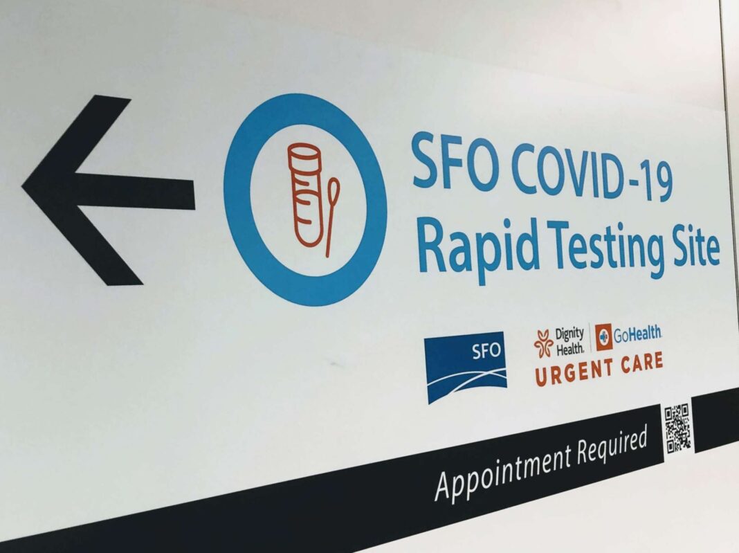A sign directs airline and airport employees to SFO's new coronavirus rapid testing site in the International Terminal.