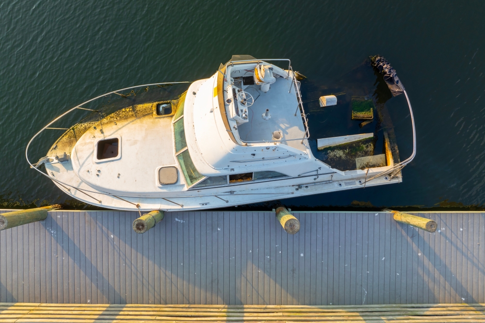 Half,Sunken,Sailing,Yacht,Capsized,On,Shallow,Bay,Waters,After